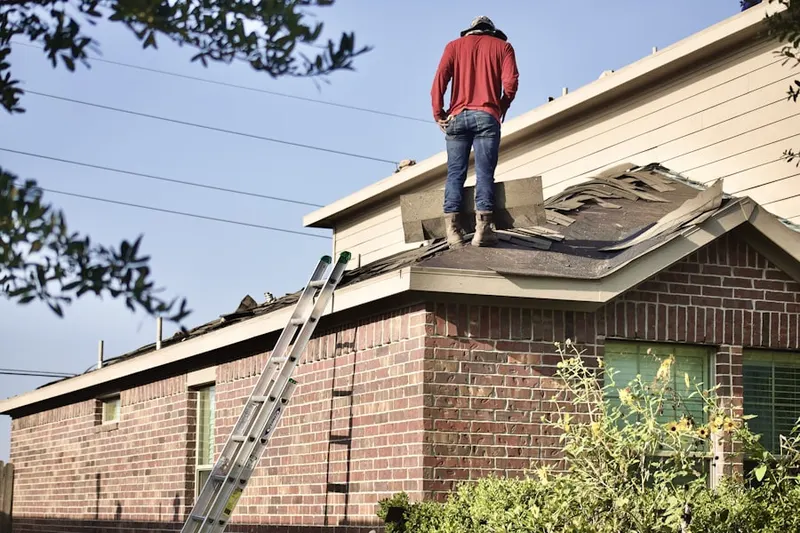 Professional roofer working on a residential roof in Constitution